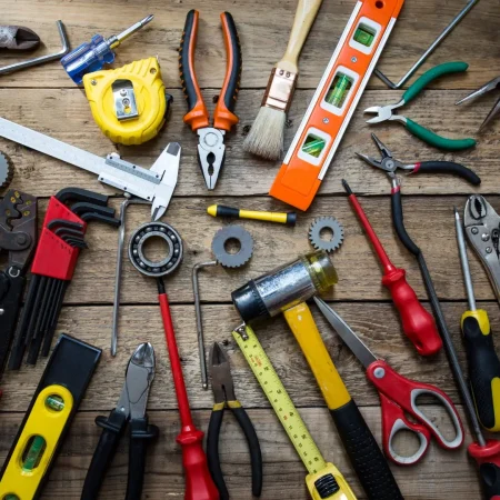 Old tools on a wooden table شركة بيتنا الحديث